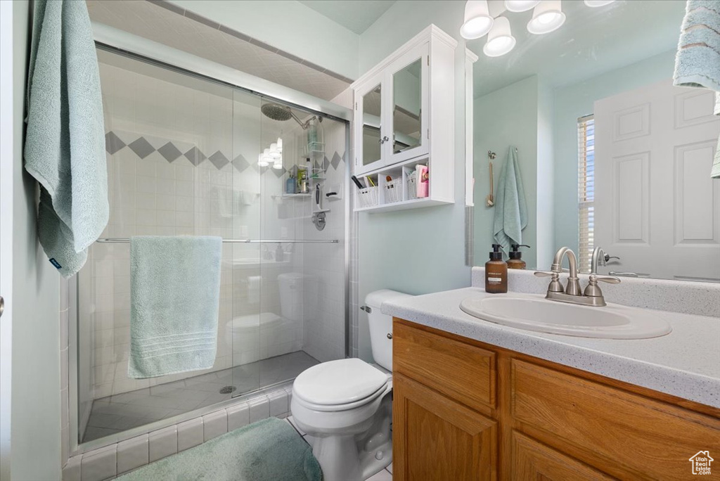 Bathroom with oversized vanity, toilet, and walk in shower