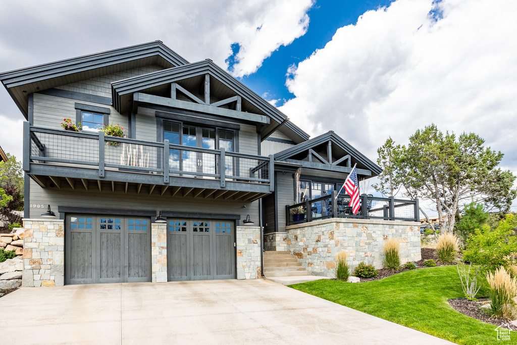 Craftsman-style home with a balcony and a garage