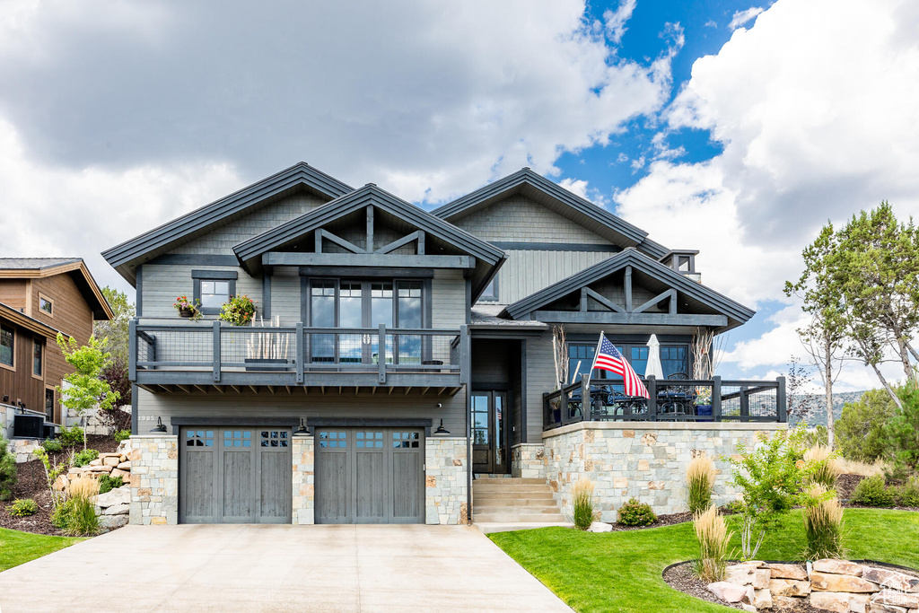 Craftsman-style home featuring central AC, a balcony, and a garage