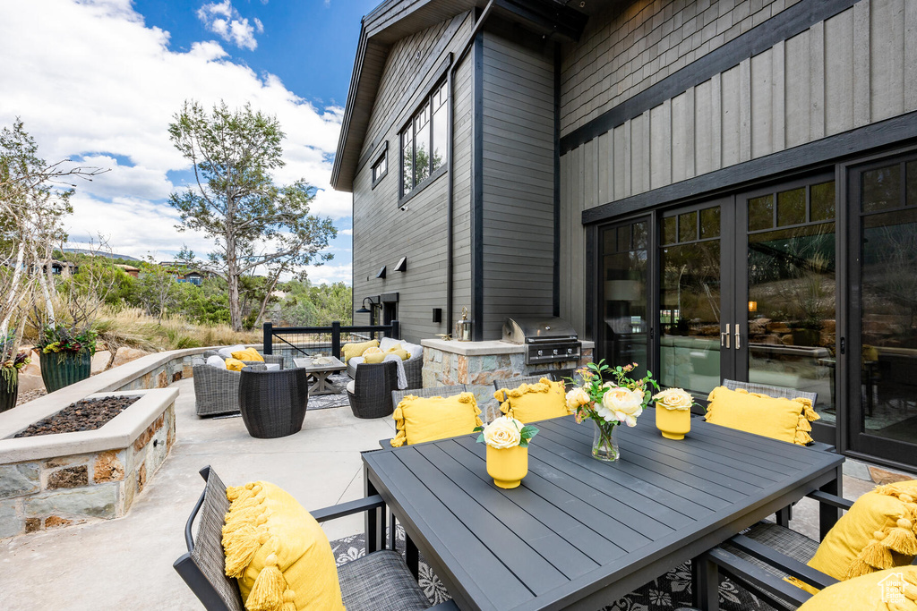 View of terrace featuring a grill, an outdoor hangout area, and exterior kitchen