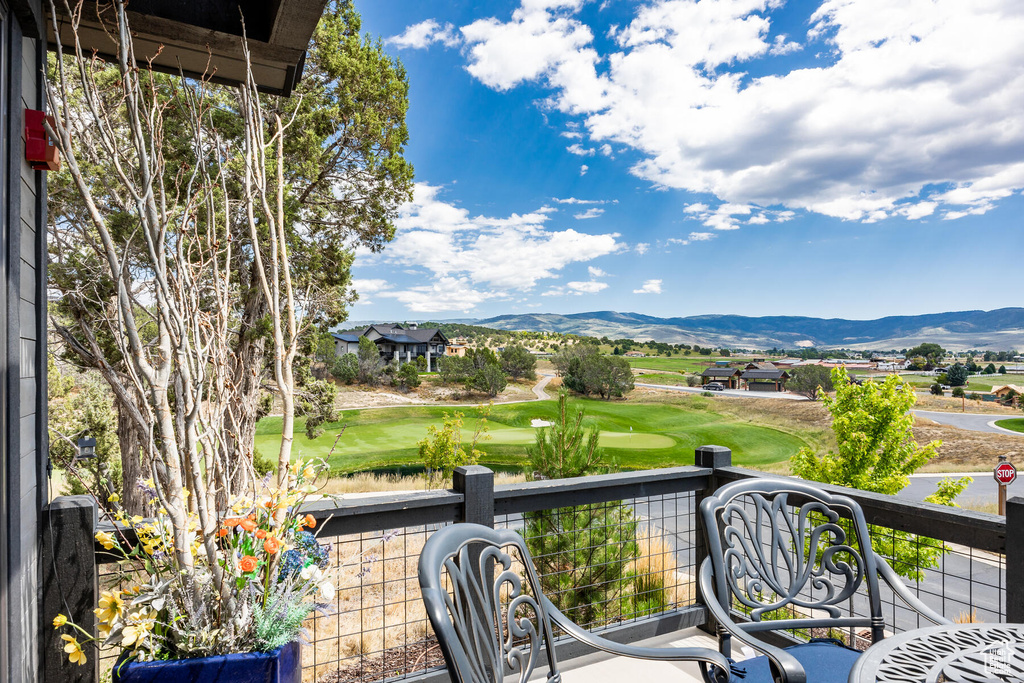 View of patio with a balcony and a mountain view