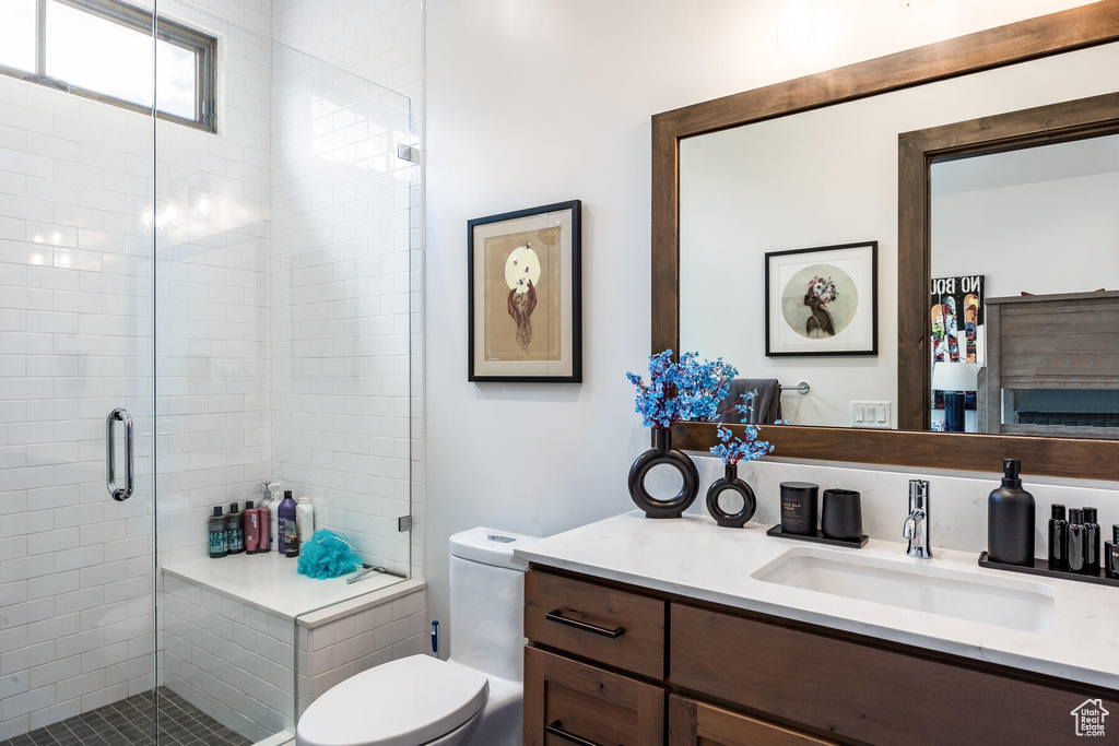 Bathroom with walk in shower, toilet, and vanity