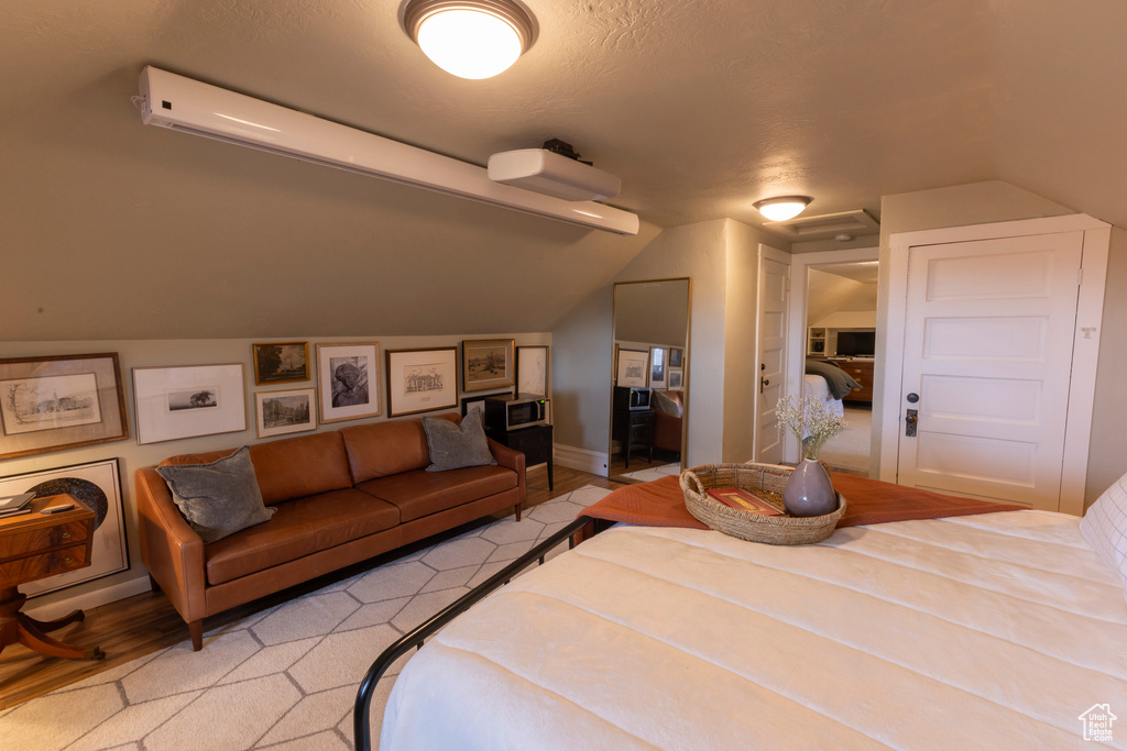 Bedroom featuring vaulted ceiling