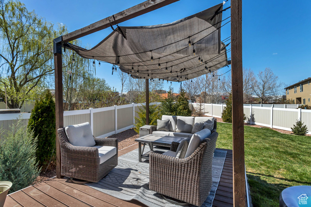 Deck featuring an outdoor hangout area and a lawn