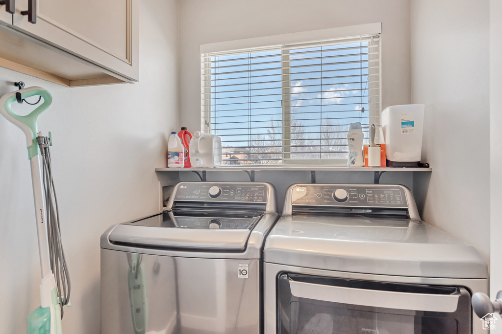 Laundry room with cabinets and washer and dryer