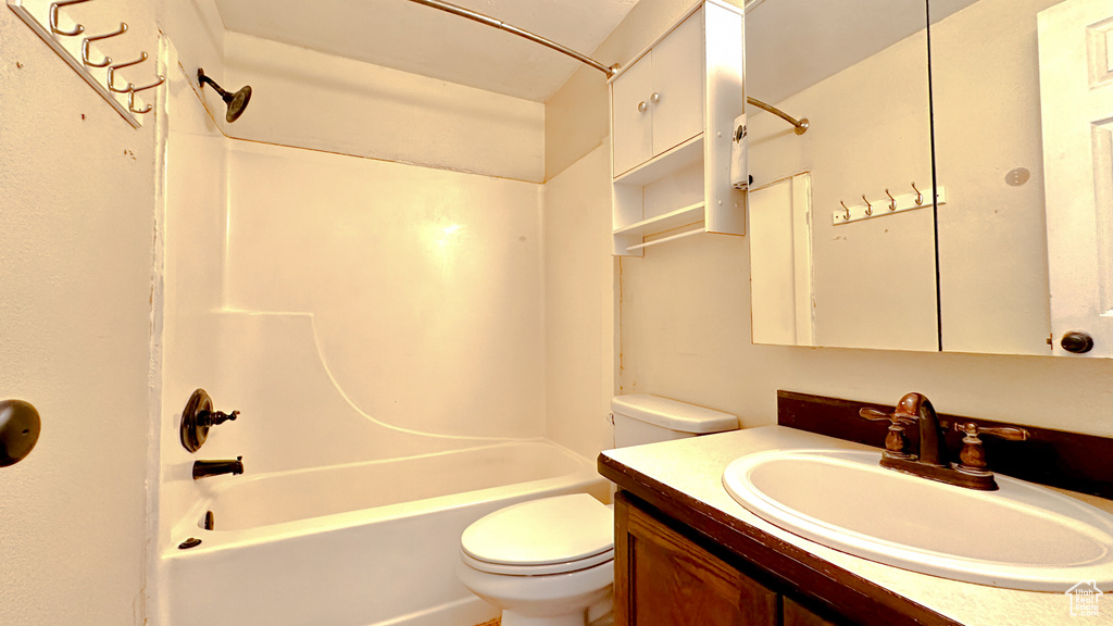 Full bathroom with tub / shower combination, toilet, and vanity