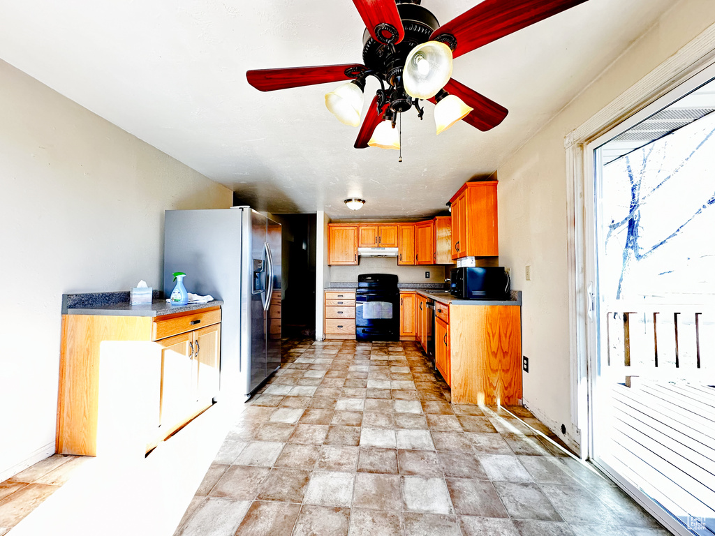 Kitchen featuring light tile floors, black appliances, and ceiling fan