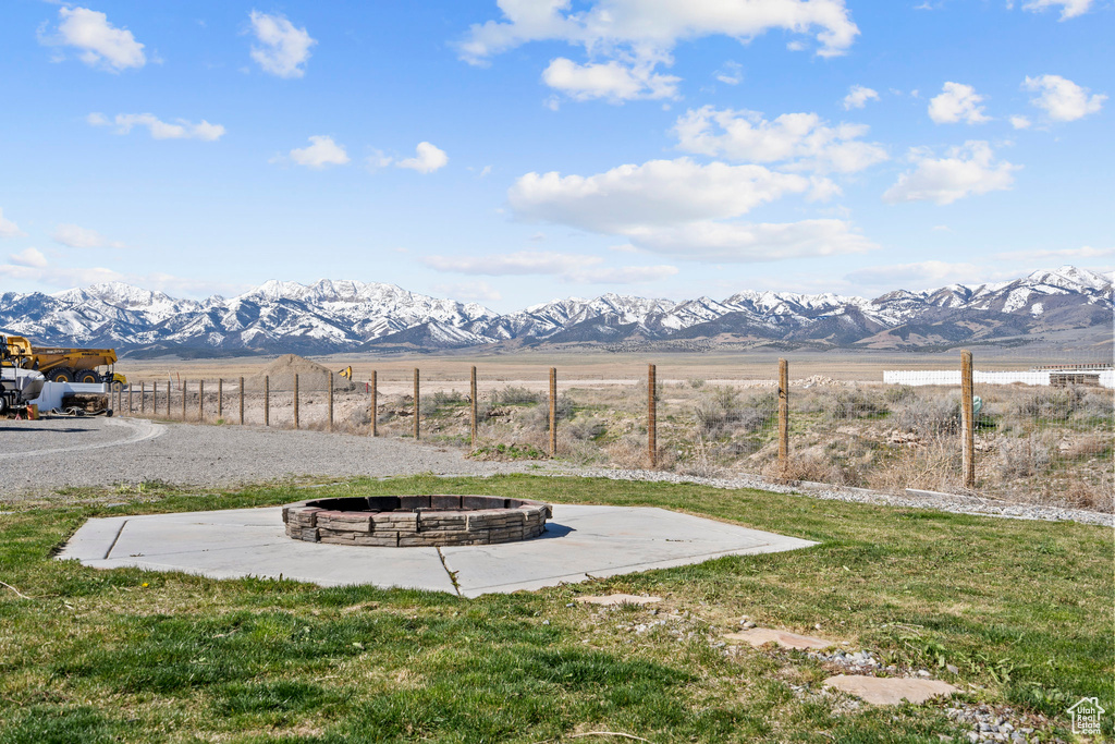 Exterior space featuring a rural view, a fire pit, and a mountain view