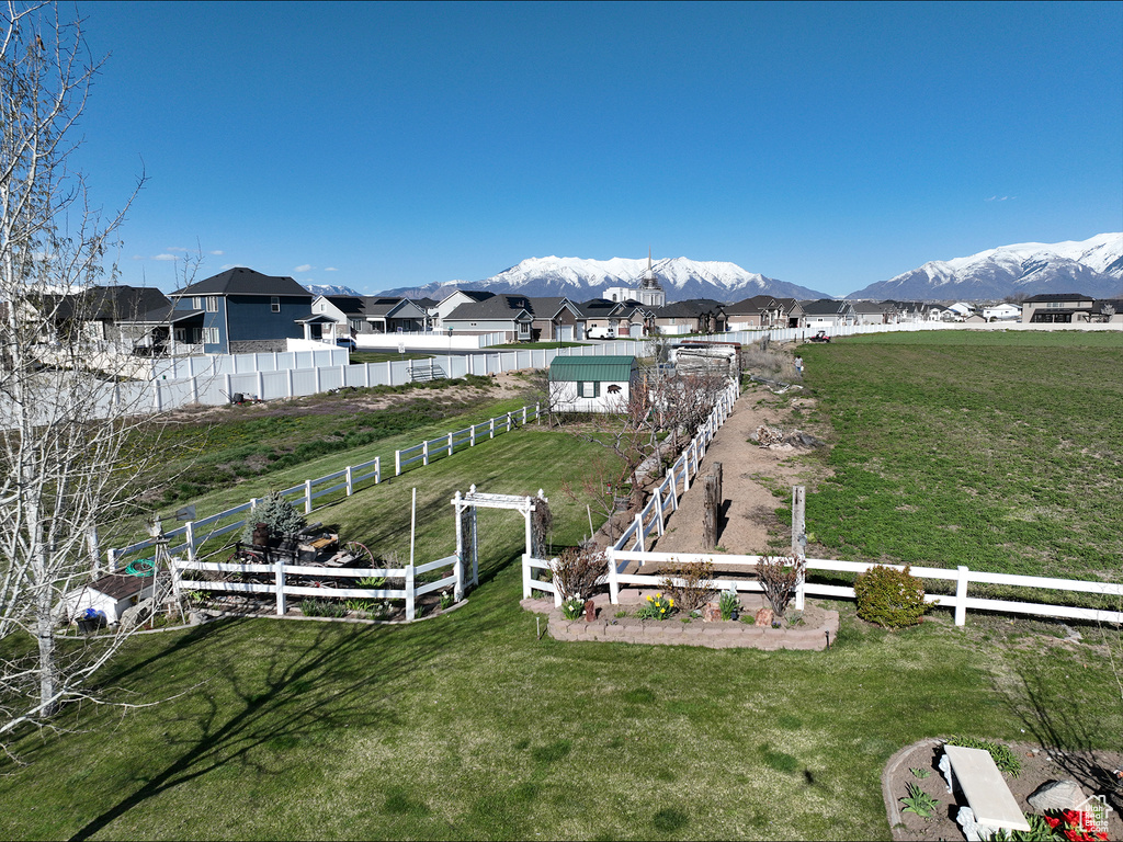 View of yard with a rural view and a mountain view