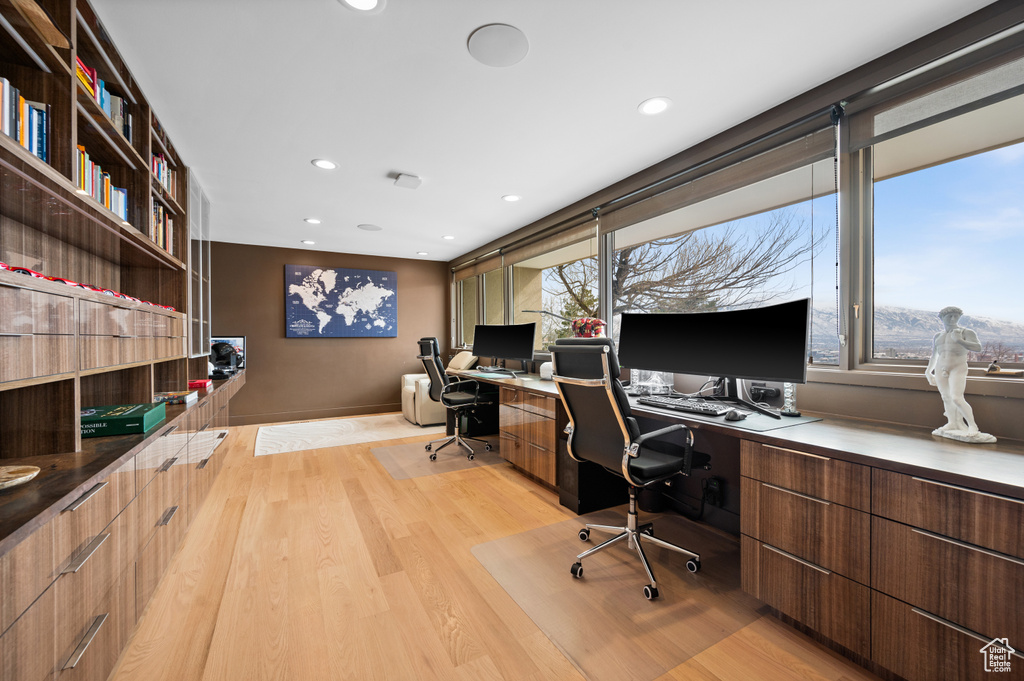 Home office featuring built in desk and light wood-type flooring