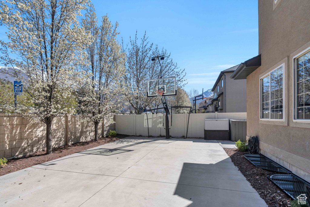 View of patio featuring basketball hoop