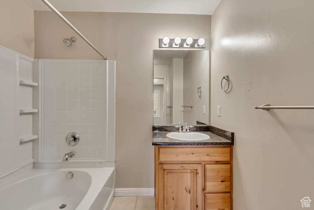 Bathroom with tile flooring, washtub / shower combination, and oversized vanity