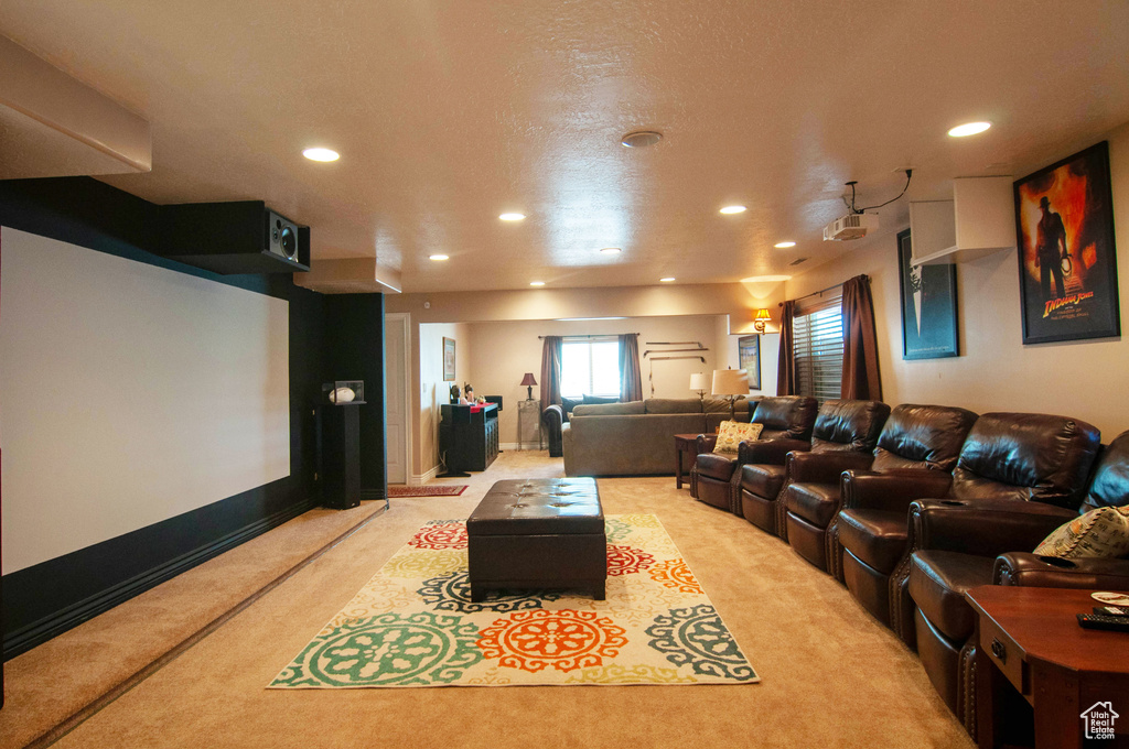 Home theater room with light colored carpet