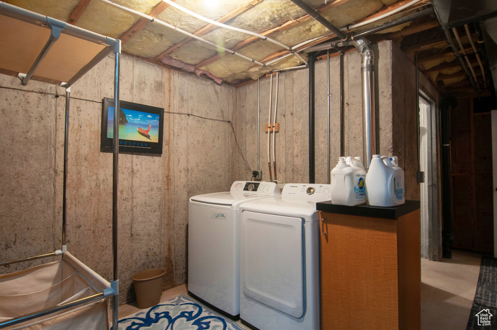 Clothes washing area featuring washer and clothes dryer and hookup for an electric dryer