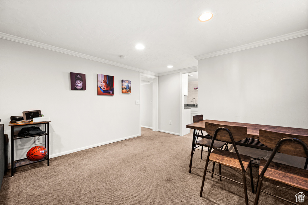 Office area with crown molding and light carpet