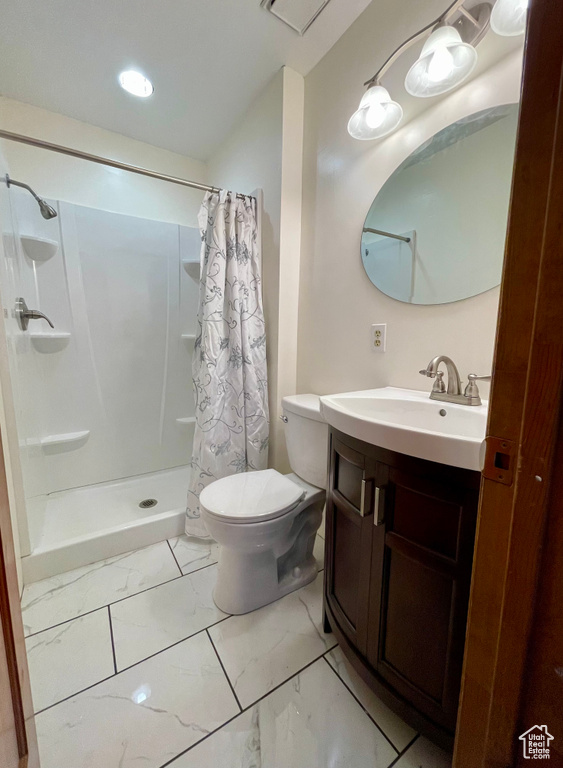Bathroom featuring curtained shower, tile flooring, toilet, and vanity