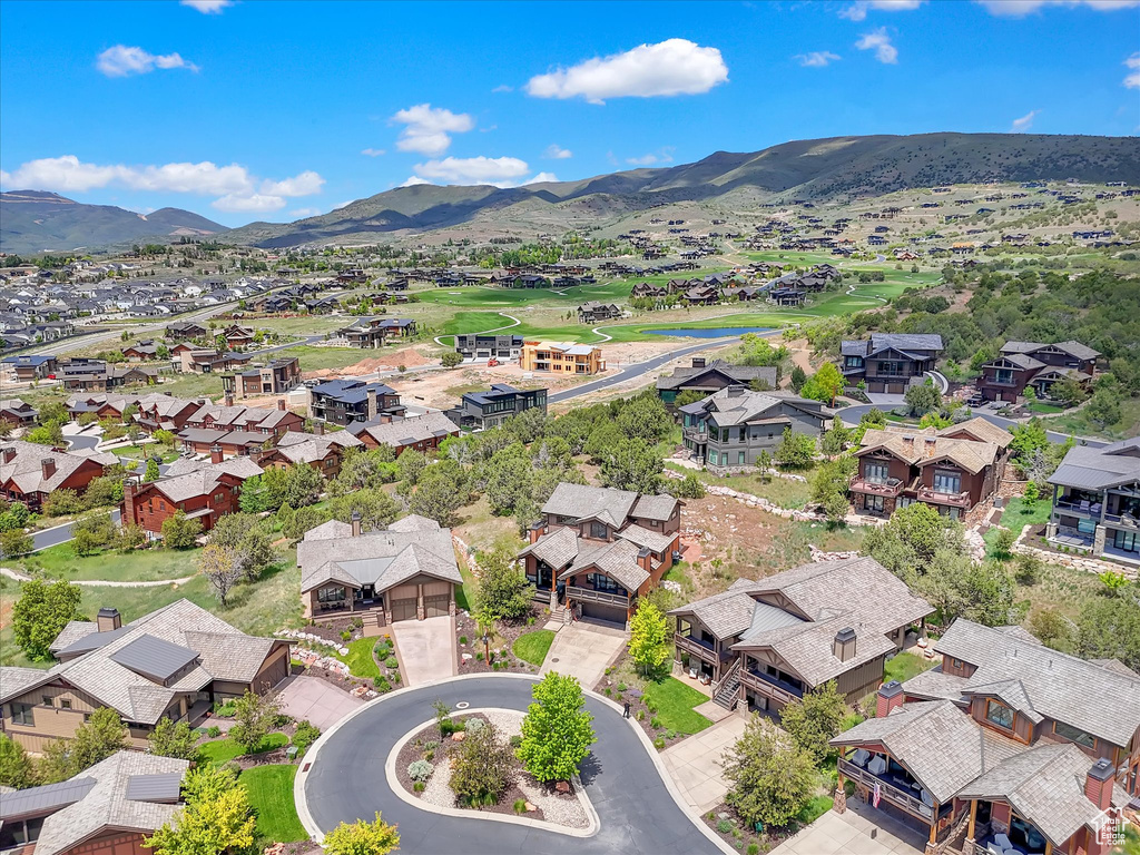 Aerial view of residential area featuring mountains and a golf club