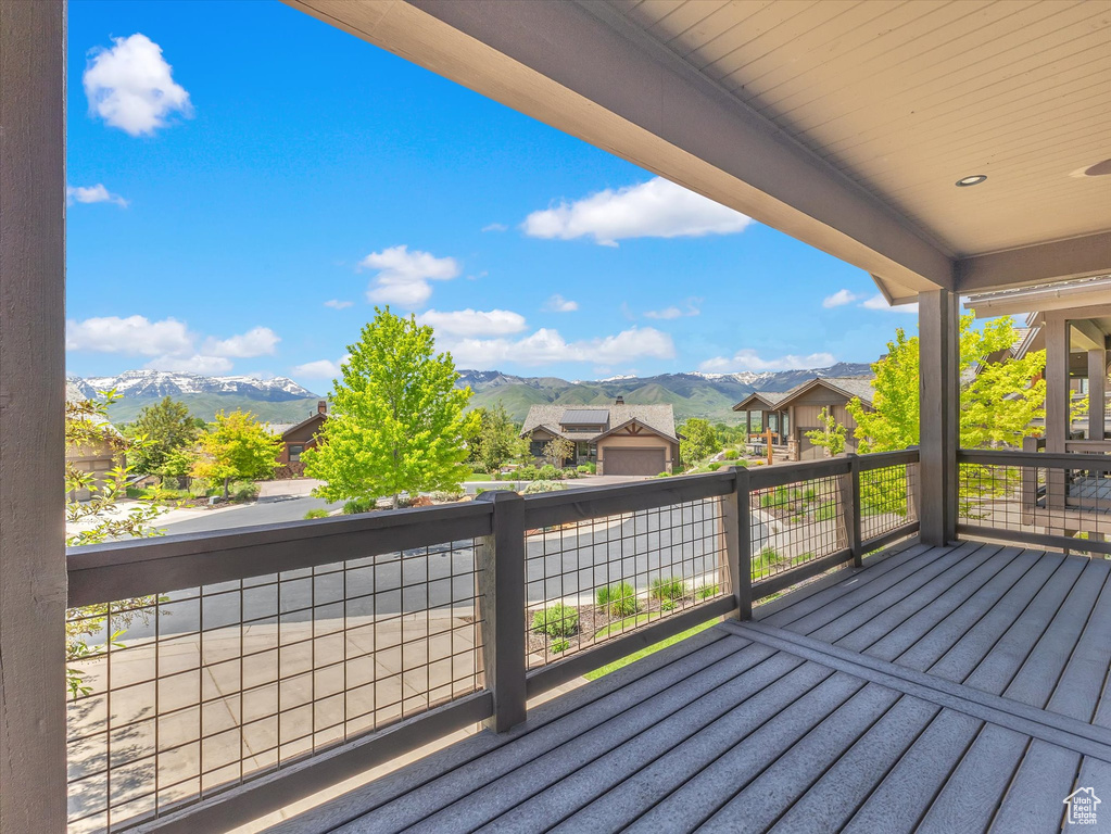 Wooden terrace featuring a mountain view and a residential view