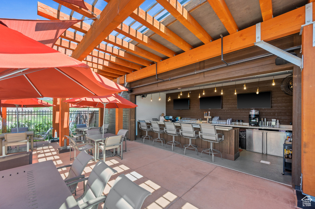 View of patio / terrace with a bar and a pergola