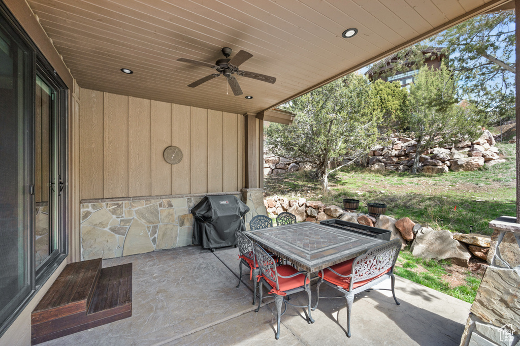 View of patio with ceiling fan and grilling area