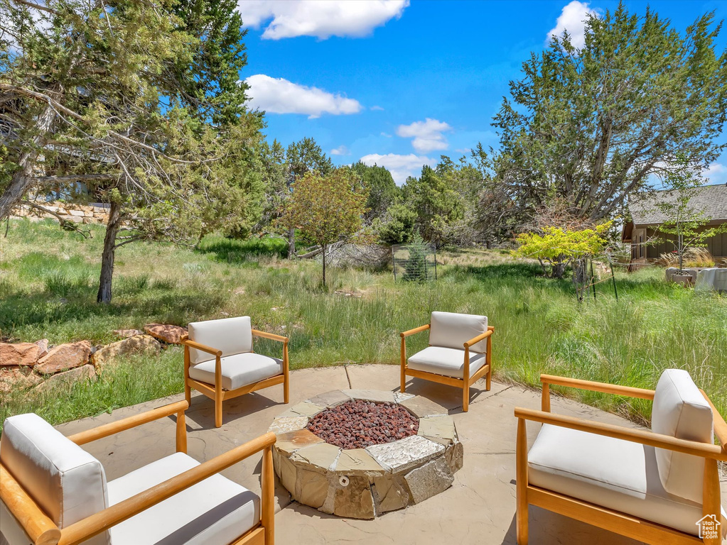 View of patio featuring an outdoor fire pit