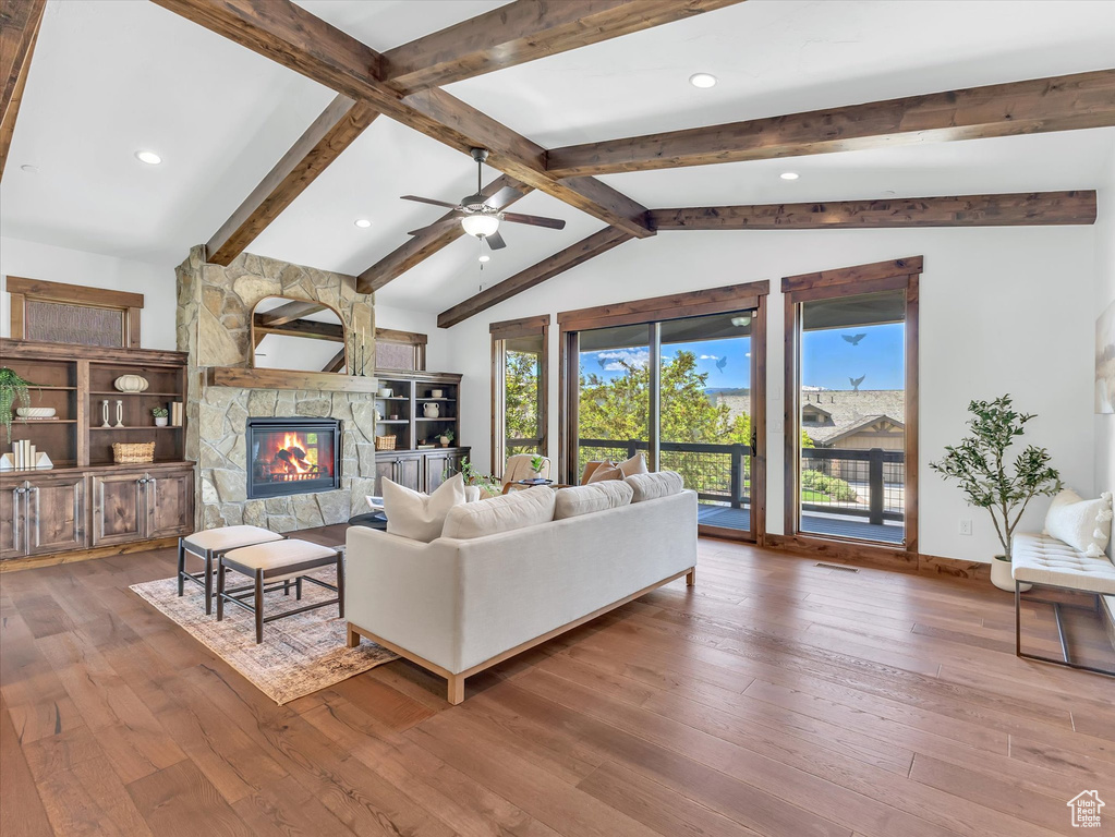 Living room with hardwood / wood-style flooring, a fireplace, ceiling fan, baseboards, and recessed lighting