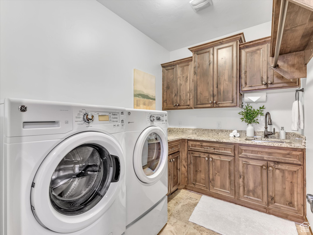 Laundry area with cabinet space and separate washer and dryer