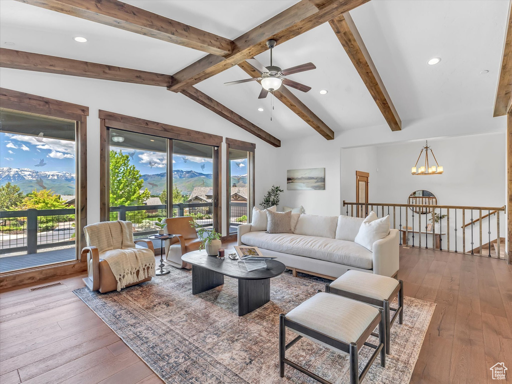 Living room with a ceiling fan, wood-type flooring, a chandelier, recessed lighting, and a mountain view
