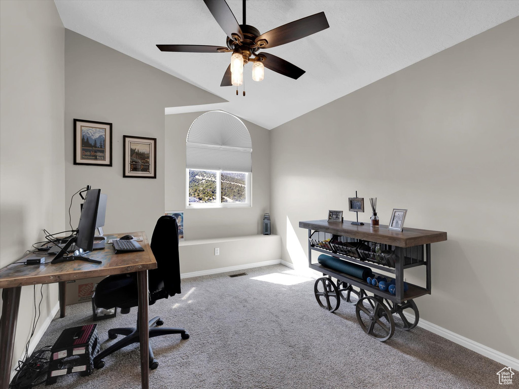 Office area with ceiling fan, lofted ceiling, and carpet floors