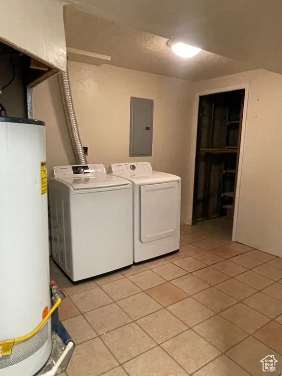 Laundry room featuring washer and clothes dryer, gas water heater, and light tile floors