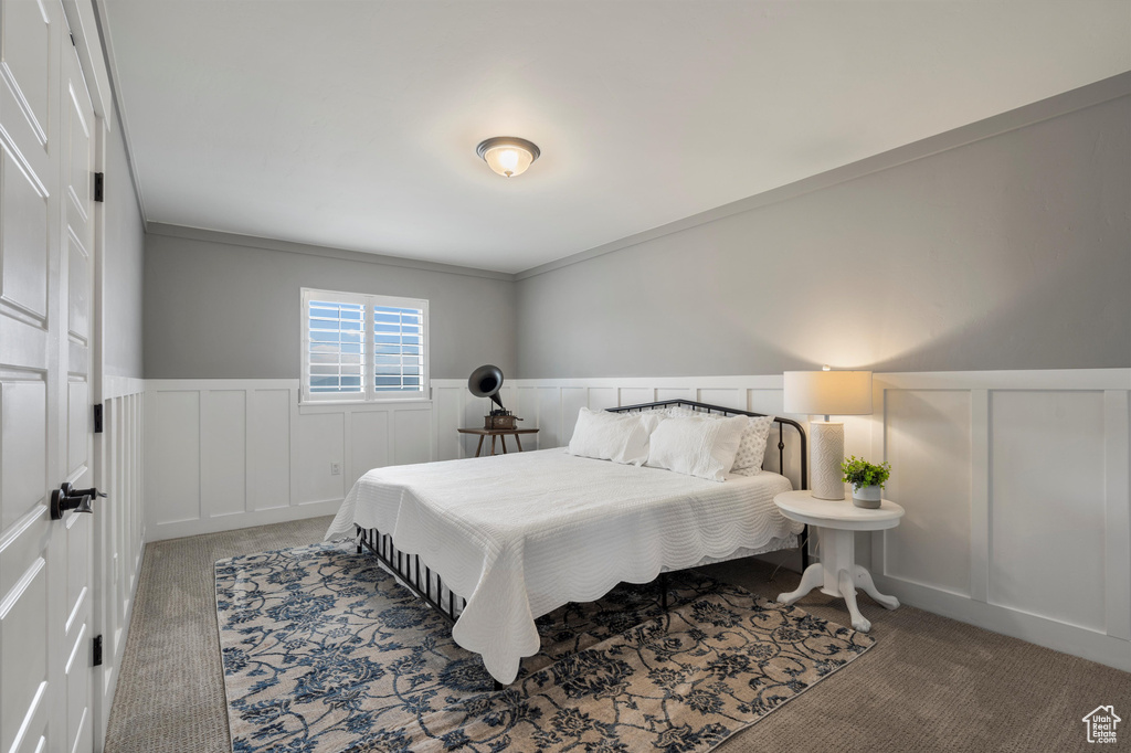 Bedroom featuring crown molding and carpet floors