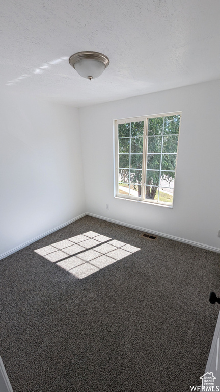 Empty room featuring carpet flooring