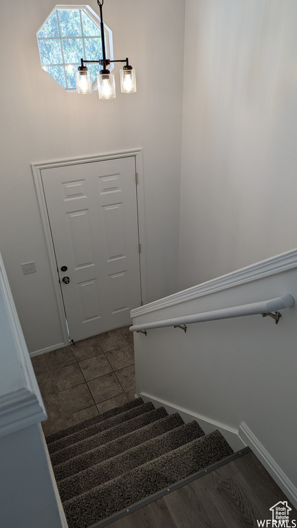 Stairway featuring dark tile flooring