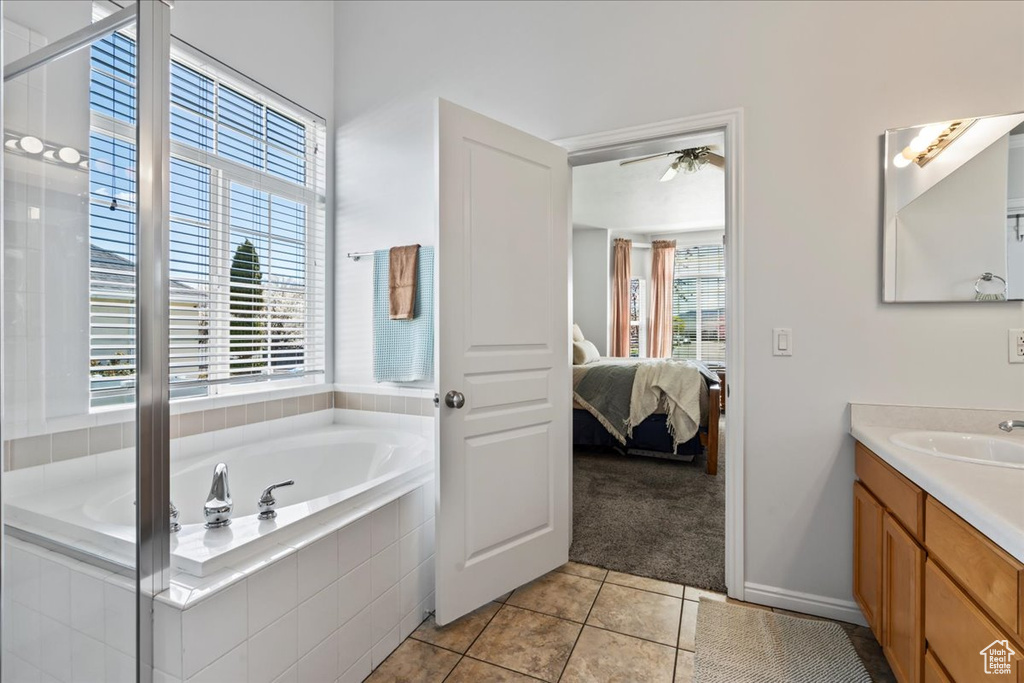 Bathroom featuring vanity, tile floors, and plenty of natural light