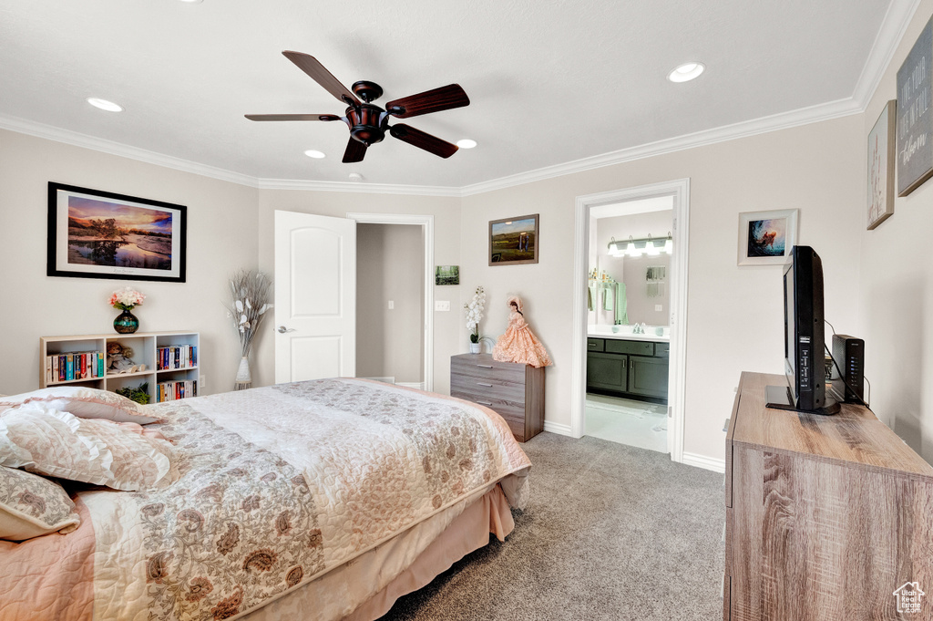 Carpeted bedroom with crown molding, ceiling fan, and ensuite bathroom