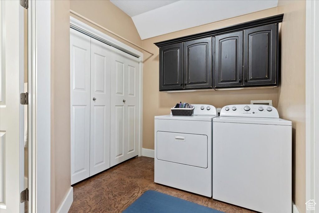 Washroom featuring cabinets and separate washer and dryer