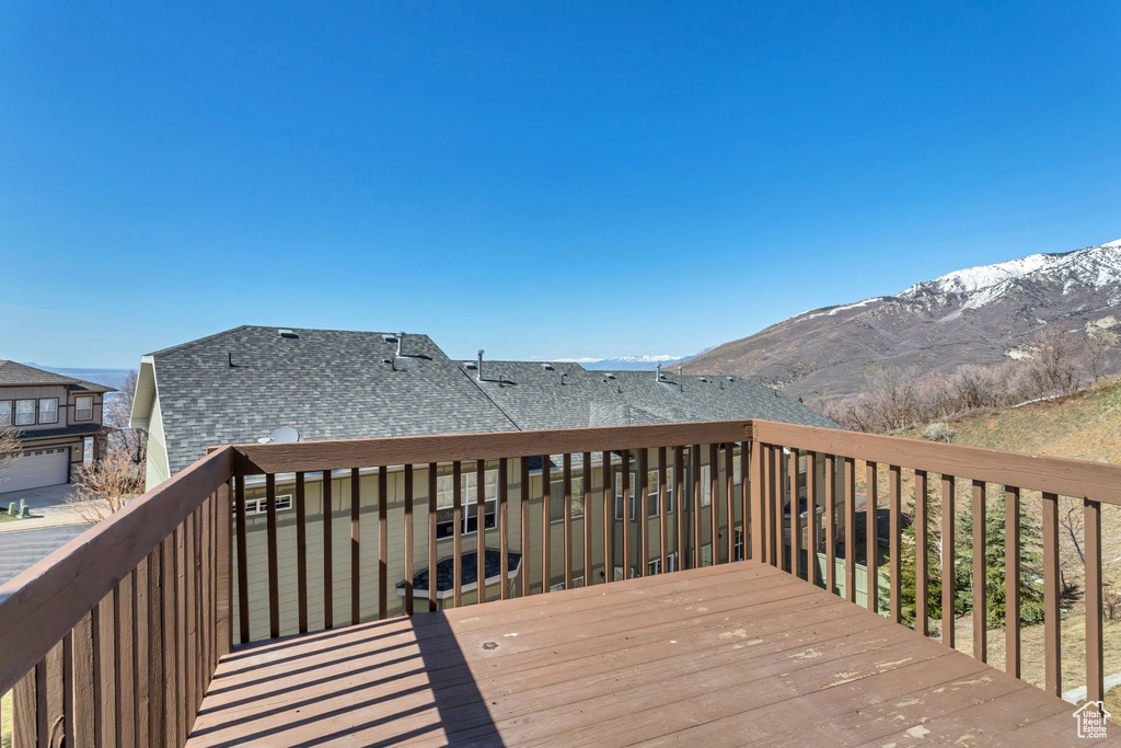Wooden deck with a mountain view and a garage