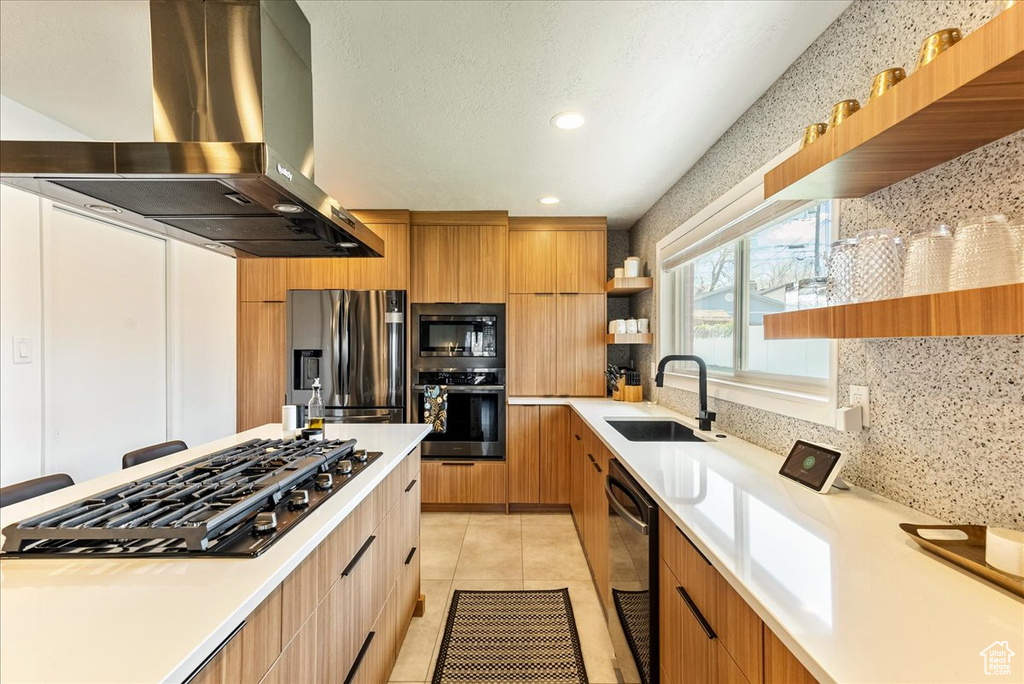 Kitchen featuring light tile floors, black appliances, sink, island exhaust hood, and tasteful backsplash