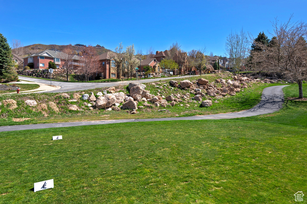 Surrounding community featuring a yard and a mountain view