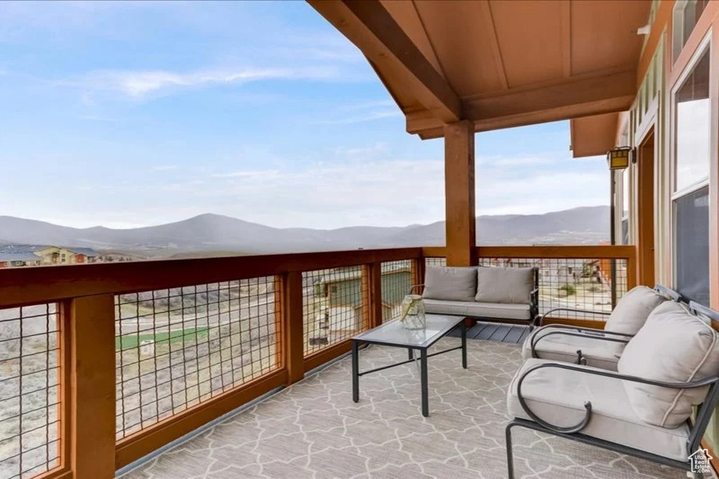 Balcony featuring a mountain view and an outdoor hangout area