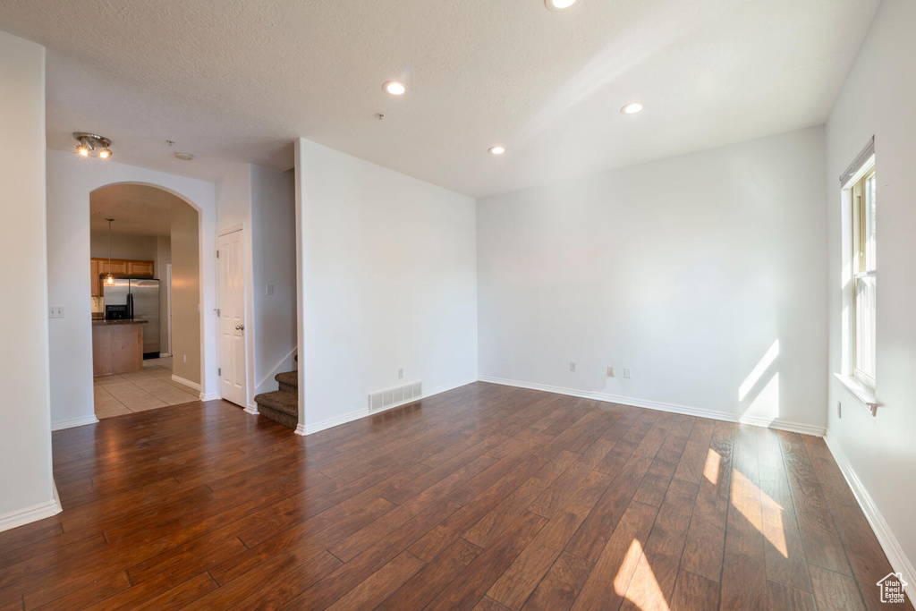 Empty room featuring hardwood / wood-style flooring and a textured ceiling