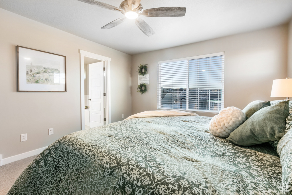 Bedroom featuring ceiling fan and carpet