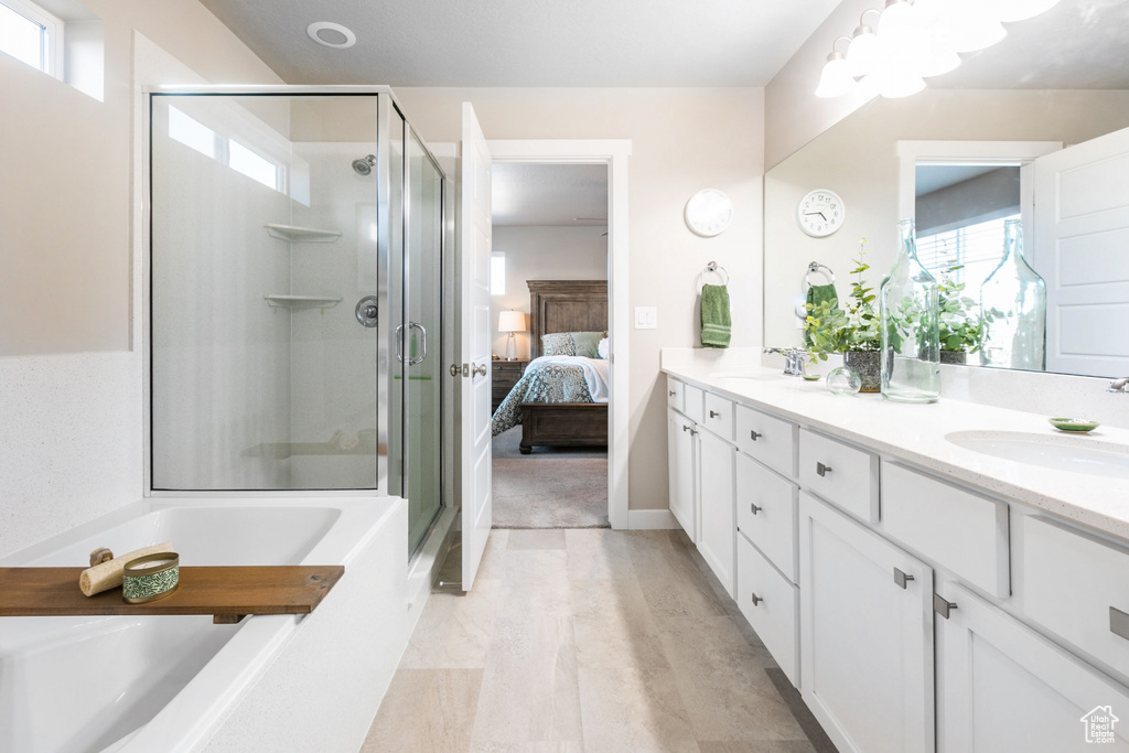 Bathroom with dual vanity and shower with separate bathtub