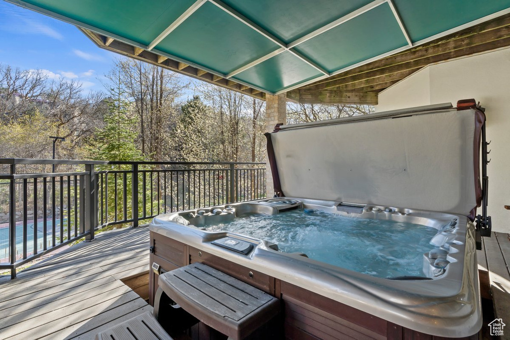 Wooden terrace with a covered hot tub