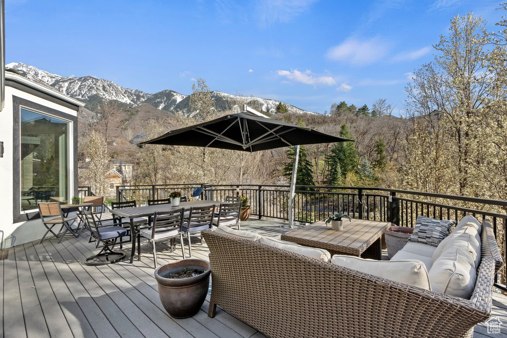 Wooden deck featuring a mountain view and outdoor lounge area