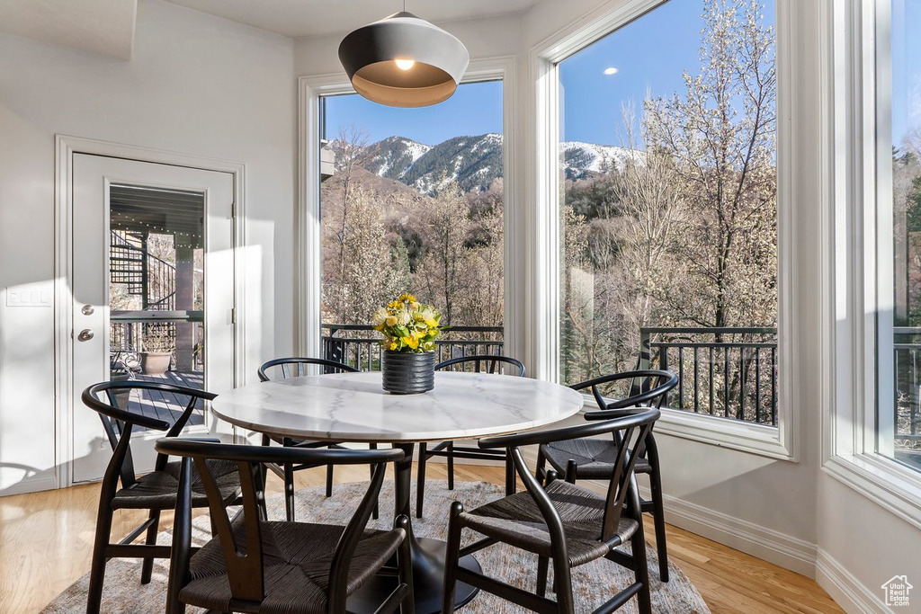 Dining space with a mountain view and light hardwood / wood-style floors