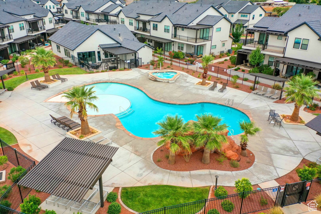 View of swimming pool with a patio and a community hot tub