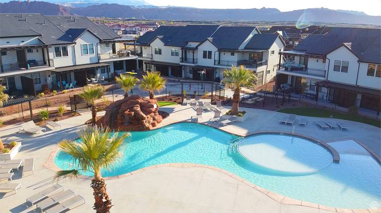 View of pool featuring a mountain view, a jacuzzi, and a patio area