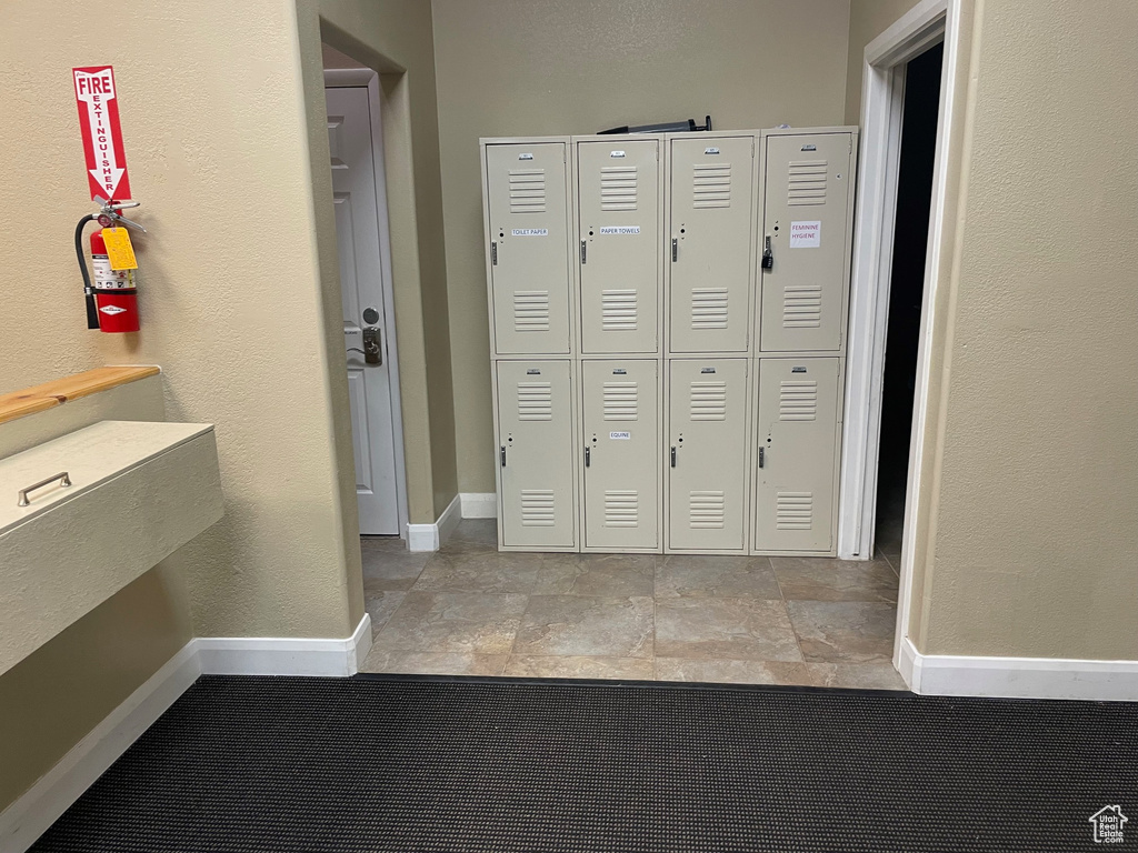 Hallway featuring light tile flooring