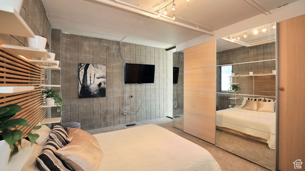 Bedroom with tile walls